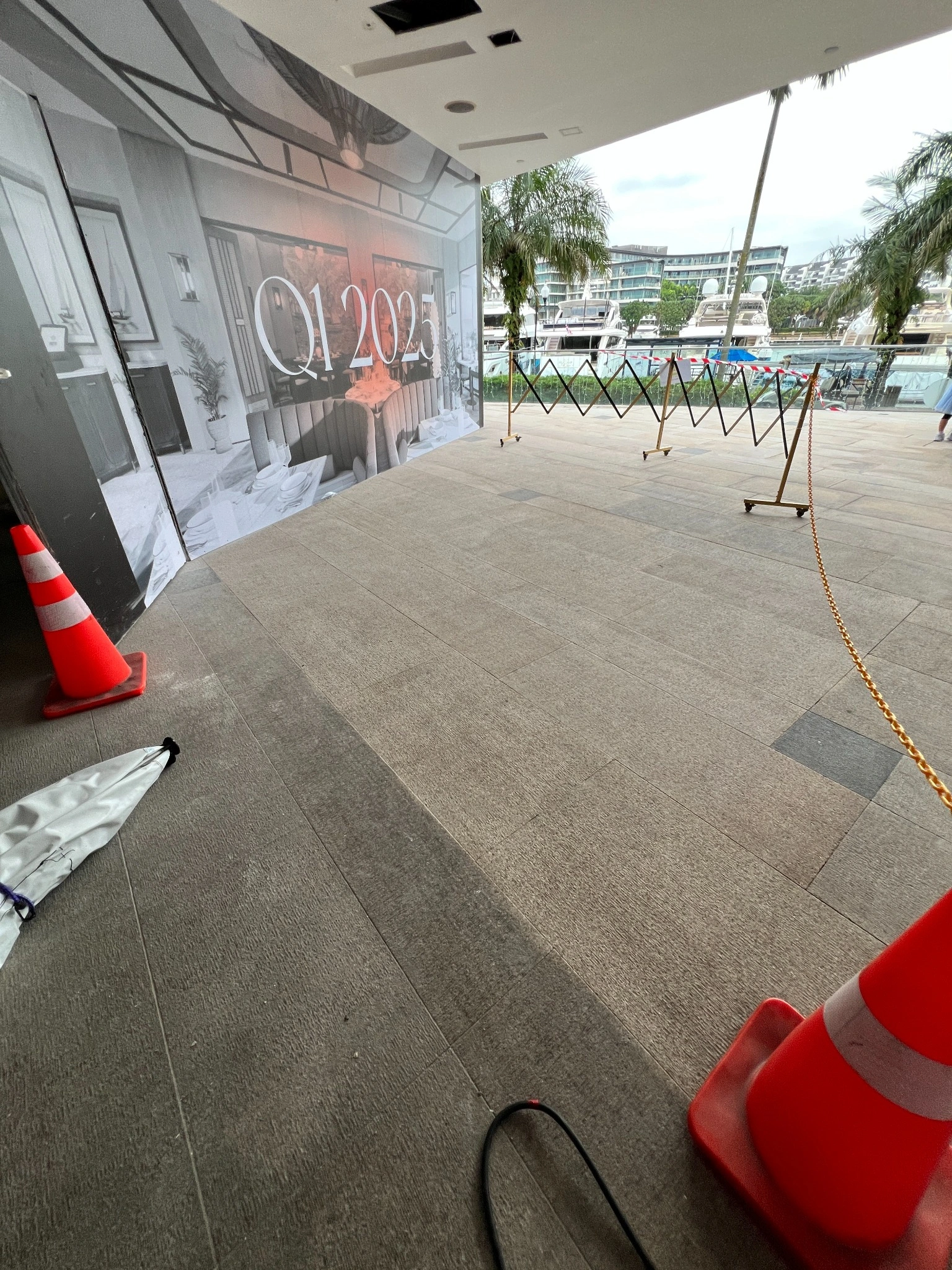 ONE°15 Marina Club granite paving: untreated darker area in foreground and left, laser-cleaned lighter area to the right